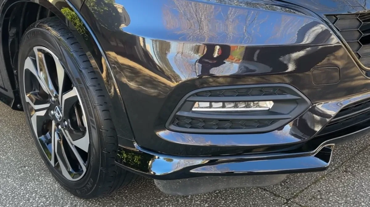 Front bumper lip scuff repaired in Brunswick — after