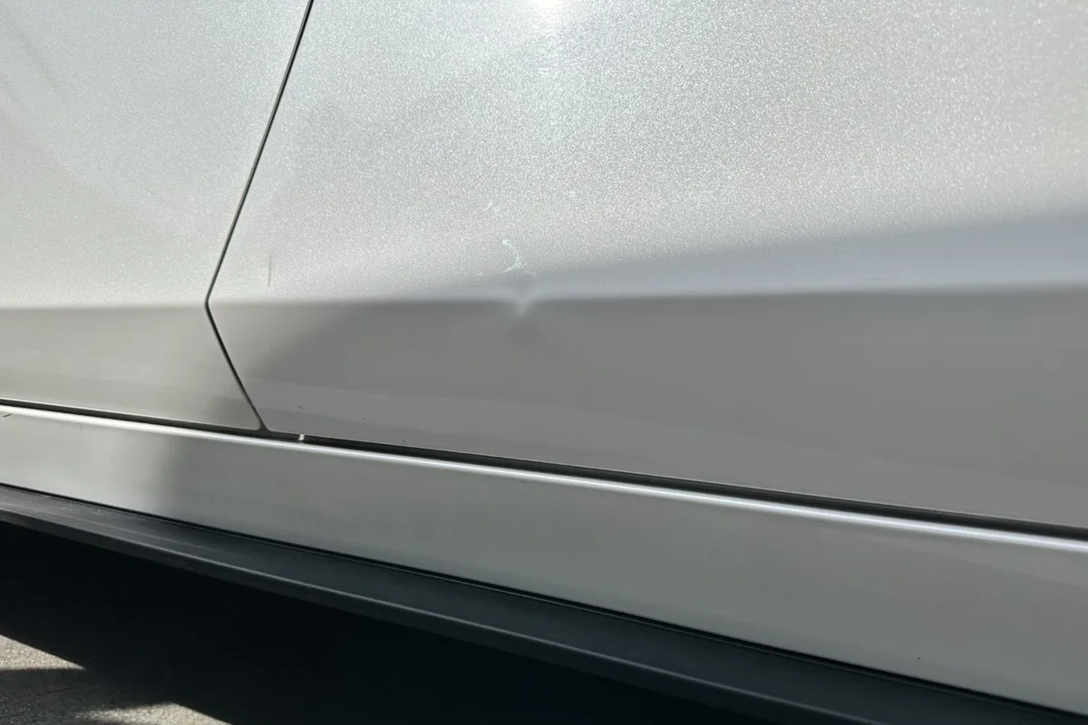 Door crease dent repaired in Doreen — before