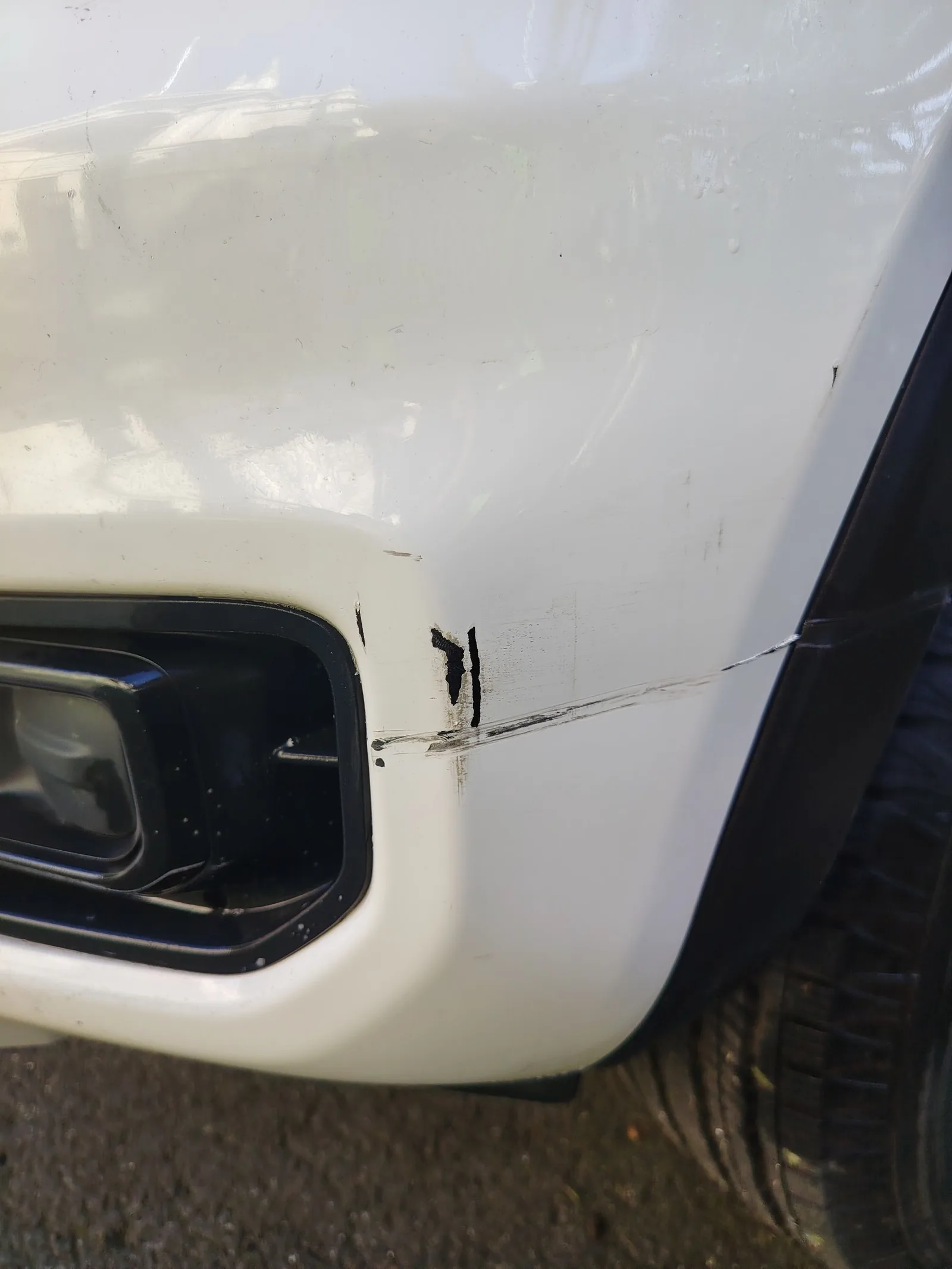 Car damage before repair - Ute Bumper Gouge Repair — Oxford White before professional scratch repair service