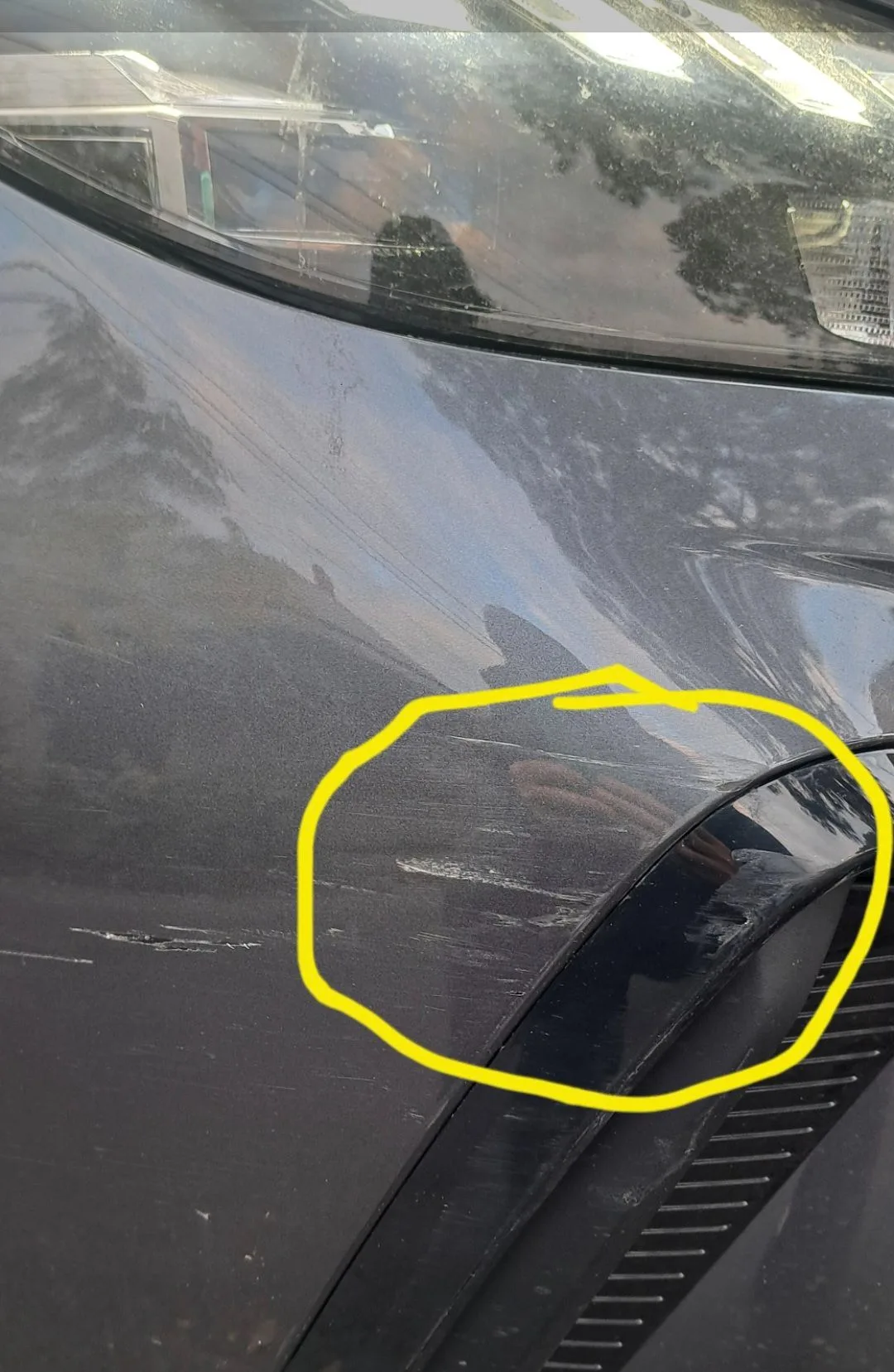 Scratched front bumper and moulding on an MG repaired in South Morang — before